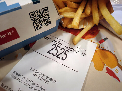 BANGKOK, THAILAND - November 28, 2022: Sales Receipt Along with Mcdonald's Fast Food Order.