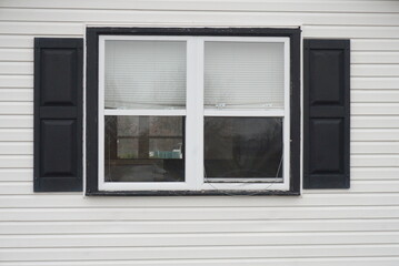 Double Window on White SIding with Black Shutters