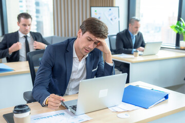Young businessman having cumulative stress from work.
