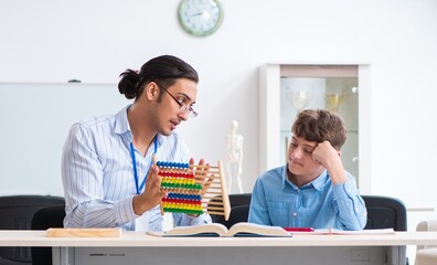 Young father helping his son to prepare for exam