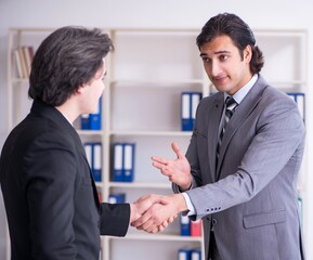 Two young businessmen meeting in the office