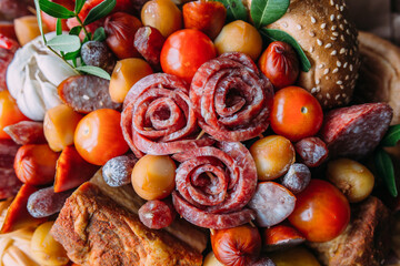 Delicious edible bouquet of sausage, tomatoes, cheese. Gift for man.