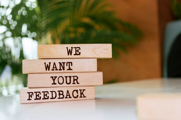 Wooden blocks with words 'We want your feedback'.