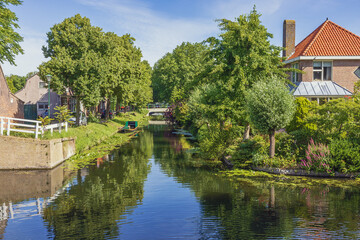 Fototapeta na wymiar The Old Canal in Enkhuizen filled with historical houses