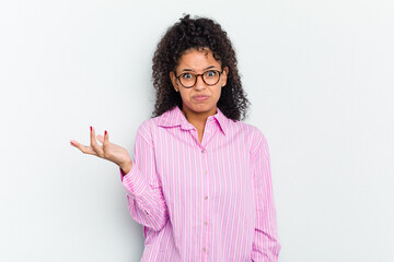 Young african american woman isolated doubting and shrugging shoulders in questioning gesture.