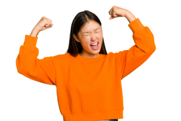Young Asian woman isolated raising fist after a victory, winner concept.