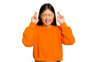 Young Asian woman isolated crossing fingers for having luck