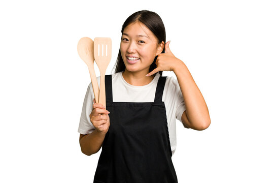 Young asian cook woman isolated showing a mobile phone call gesture with fingers.