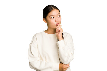 Young Asian woman isolated relaxed thinking about something looking at a copy space.
