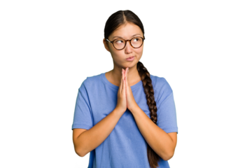 Young Asian woman isolated holding hands in pray near mouth, feels confident.