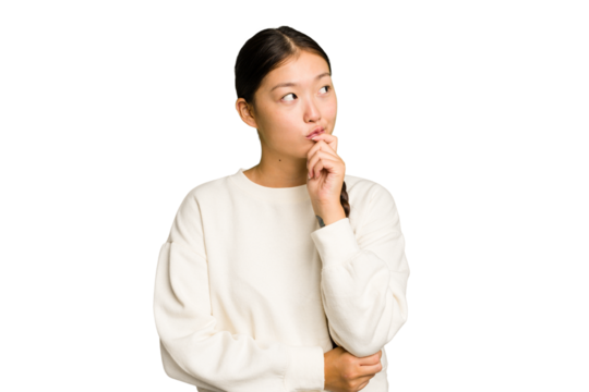 Young Asian woman isolated relaxed thinking about something looking at a copy space.