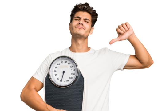 Young caucasian man holding a scale isolated feels proud and self confident, example to follow.