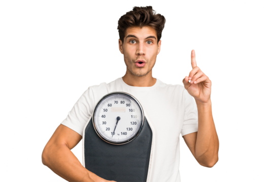 Young caucasian man holding a scale isolated having some great idea, concept of creativity.