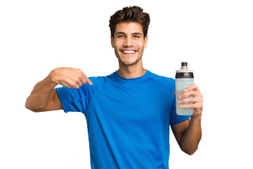 Young sport caucasian man holding a bottle of water isolated person pointing by hand to a shirt...