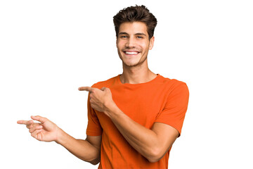 Young caucasian handsome man isolated excited pointing with forefingers away.