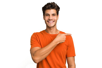 Young caucasian handsome man isolated smiling and pointing aside, showing something at blank space.