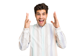 Young caucasian handsome man isolated celebrating a victory or success, he is surprised and shocked.