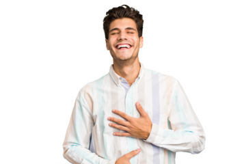 Young caucasian handsome man isolated laughs happily and has fun keeping hands on stomach.