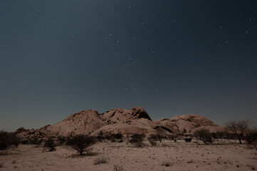 Obraz na płótnie Canvas Night shot of the Namibian Desert near Spitzkoppe, under a clear starry southern sky.