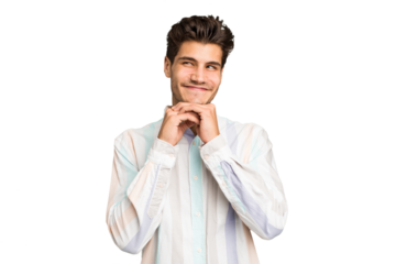 Young caucasian handsome man isolated keeps hands under chin, is looking happily aside.