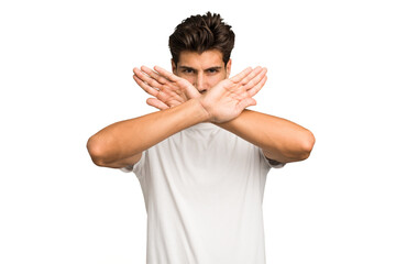 Young caucasian handsome man isolated doing a denial gesture