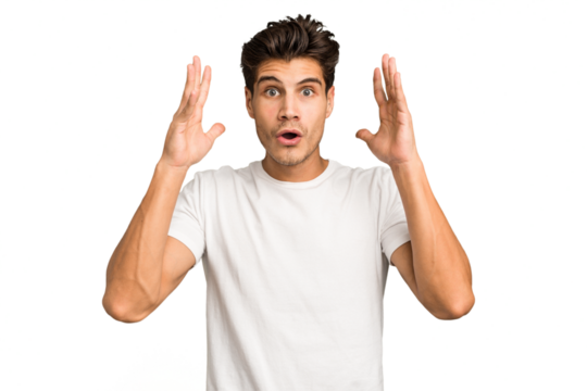Young caucasian handsome man isolated celebrating a victory or success, he is surprised and shocked.