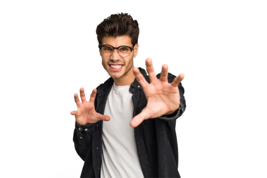 Young caucasian handsome man isolated showing claws imitating a cat, aggressive gesture.