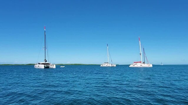 Crystal clear caribbean sea with ancored catamarans, Los Roques Archipelago