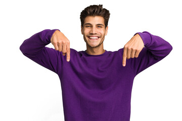 Young caucasian handsome man isolated points down with fingers, positive feeling.