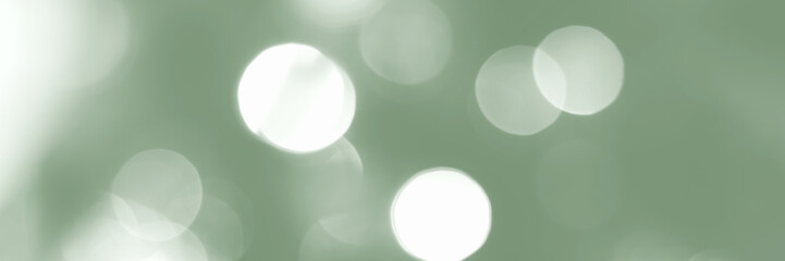 Blurred lights, green background, banner texture. Abstract bokeh with soft light header. Wide screen wallpaper. Panoramic web banner with copy space for design