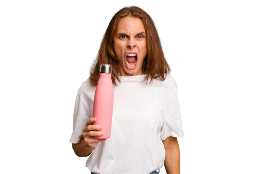Young caucasian woman holding a pink thermo isolated screaming very angry and aggressive.