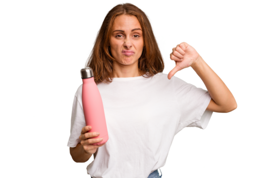 Young caucasian woman holding a pink thermo isolated showing a dislike gesture, thumbs down. Disagreement concept.