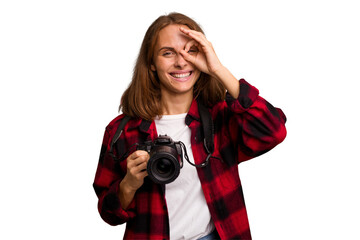 Young photographer caucasian woman isolated excited keeping ok gesture on eye.
