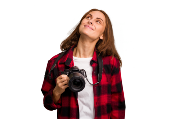 Young photographer caucasian woman isolated dreaming of achieving goals and purposes