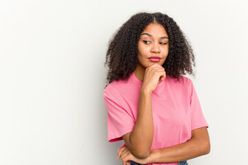 Young african american woman isolated on white background looking sideways with doubtful and skeptical expression.