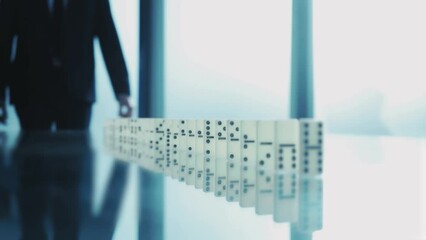 business partner confidently stopping the domino effect.