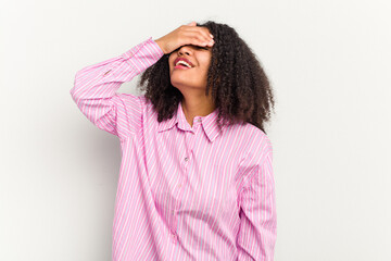 Young african american woman isolated on white background laughs joyfully keeping hands on head. Happiness concept.