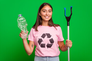 Young caucasian woman holding a plastic bottle with a pick up stick isolated