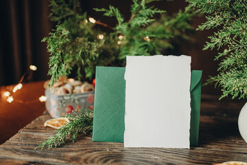 Mockup of white sheet of paper on the table with christmas decor, christmas letter mockup,...