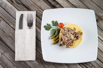 Plate of mashed potatoes with fried mushrooms and champignons. Rustic style, simple light food.