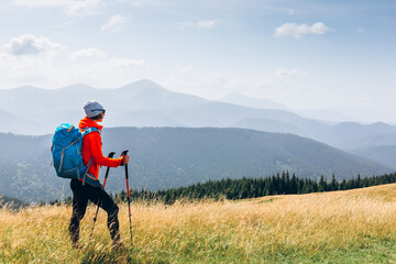 Hiker Young Woman With Backpack in the Mountain Top. Discovery Travel Destination Concept