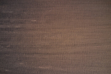 Brown plowed field. Earth top view. Brown background on the field aerial view.