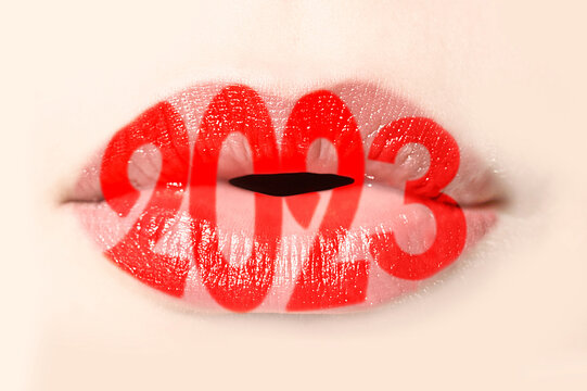 2023 written with red lipstick on girl lips