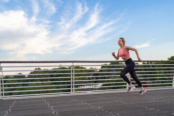 horizontal photo of strong woman running in the city, copy space, fitness concept