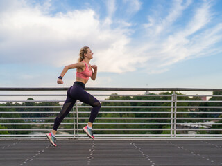 horizontal photo of strong woman running in the city, copy space, fitness concept