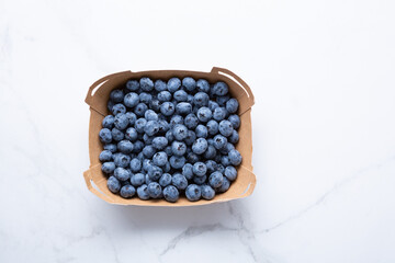 Top view fresh blueberry in box on light surface