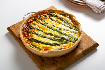 Whole vegetables pie quiche with asparagus spring food close up