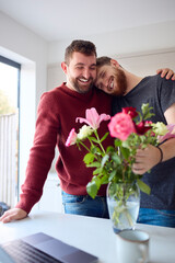 Loving Same Sex Male Couple Hugging In Kitchen Of New Home