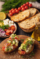 Tasty and healthy avocado, cherry tomatoes and feta cheese sandwiches. Toasts  with avocado, tomatoes and feta cheese.