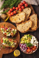 Tasty and healthy avocado, cherry tomatoes and feta cheese sandwiches. Toasts  with avocado, tomatoes and feta cheese.